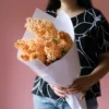 Wrapped bouquet of apricot hyacinths.