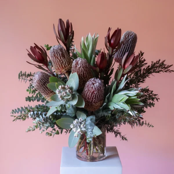 Australian native flower arrangment in vase with banksias, gum nuts and leucadendron.