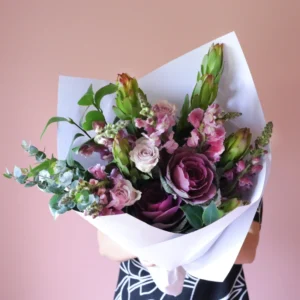 Flower bouquet with purple kale, rose and snap dragons.