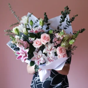 Flower bouquet with pastel roses and rose lilies.